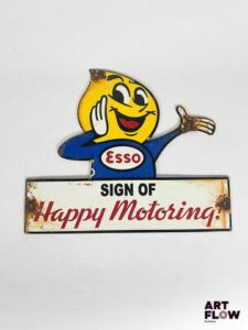 Plaque émaillée Esso Happy Motoring Dimensions : 24,5 x 30 cm Petits éclats et traces de rouille Reproduction moderne