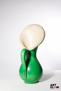 POL CHAMBOST (1906-1983) Pichet 837 en faience émaillée à couverte verte à l'extérieur, beige à l'intérieur. Incisé sous la base "Poterie Pol Chambost" et tampon "837". 40 x 18 x 18 cm env. Bibliographie : Philippe Chambost, "Pol Chambost, Sculpteur-Céramiste 1906-1983", Somogy Editions d'Art, Paris, 2006, modèle similaire p. 55 ; p. 136