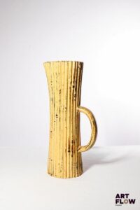 POL CHAMBOST (1906-1983) Pichet en faience émaillée à couverte polychrome, de nforme oblongue striée. Incisé sous la base "Made in France, Poterie Pol Chambost, déposé" H. 32 cm Bibliographie : Philippe Chambost, "Pol Chambost, Sculpteur-Céramiste 1906-1983", Somogy Editions d'Art, Paris, 2006, modèle similaire p. 96