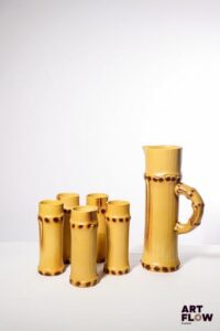 POL CHAMBOST (1906-1983) Service à orangeade 2002 "Bambou" en faience émaillée à décor polychrome naturaliste, comprenant un pichet et 5 verres. Le pichet incisé au revers "2002, Poterie Pol Chambost, Made in France, Déposé", et les verres "2003, Poterie Pol Chambost, Made in France" H. pichet 30,5 H. verres 17 cm Deux légers fêles à l'intérieur de l'un des verres Bibliographie : Philippe Chambost, "Pol Chambost, Sculpteur-Céramiste 1906-1983", Somogy Editions d'Art, Paris, 2006, modèle similaire p. 145
