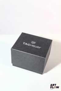 TAG HEUER Sur boite en carton noir Inscription Tag Heuer sur le couvercle 13 x 15 x 11,5 cm Bon état général