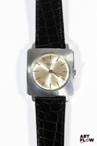 UNIVERSAL GENÈVE Montre bracelet homme en acier, à mouvement mécanique à remontage manuel, le boîtier de forme cioccolatone à cadran à fond soleillé, index bâtons, lunette soleillé, le bracelet en cuir noir. Années 1960 28 x 28mm Longueur du bracelet : 17 cm env. Référence 282162 Fondée en 1894, Universal Genève s’est imposée comme une maison pionnière du chronographe, devenue mythique grâce à des modèles iconiques comme la Compax et la Tri-Compax, symboles de l’âge d’or de l’horlogerie suisse. Bon état général (rayures sur le fond de boîte et sur le boitier) Fonctionnelle au moment de la rédaction du catalogue, révisé récemment, mécanisme non garanti.