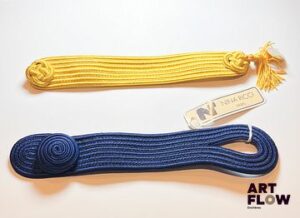 Nina RICCI Bracelet en tissu fermé par un bouton assorti Tour de poignet en 17cm On y joint un bracelet similaire jaune au fermoir accidenté