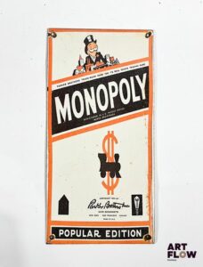 Plaque émaillée rectangulaire Monopoly 30,5 x 15 cm éclats et traces de rouille (fin XXe-début XXIe siècle)