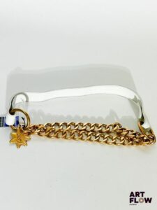 YVES SAINT LAURENT Ceinture en cuir blanc et chaîne, avec une bijouterie dorée et un charm en forme d'étoile portant l'inscription « YSL ». Dimensions : 88 × 2,5 cm environ. Traces d'usure et décoloration de la bijouterie.